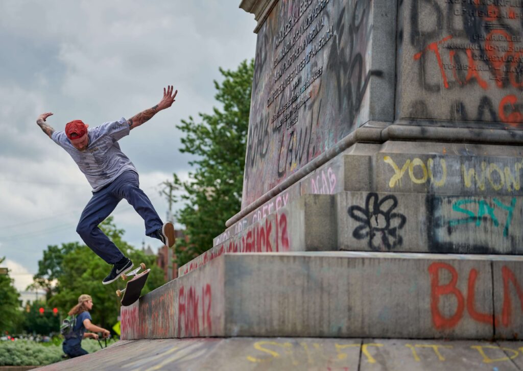 A skateboard skating on the graffiti-covered granite base of the J.E.B. Stuart Monument in Richmond in 2020.