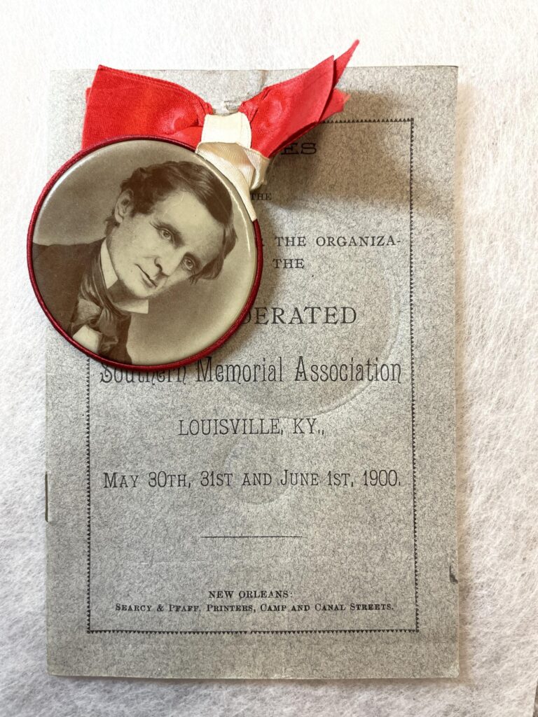 A 1900 program for the Confederated Southern Memorial Association with an image of Jefferson Davis on the backside of a button.
