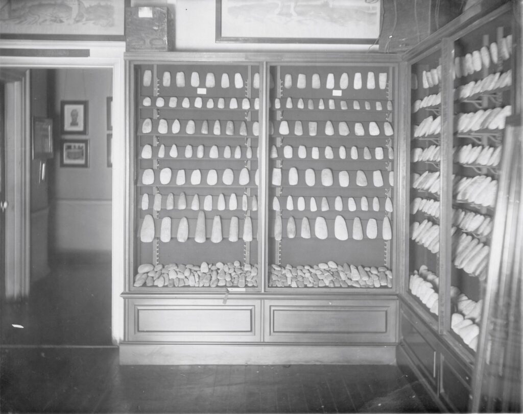 View of the early Valentine Museum showing glass cases full of stone tools.