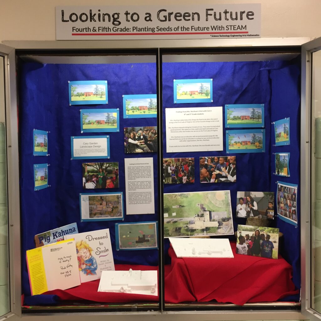 Exhibit window for Cary Elementary. "Looking to a Green Future: Fourth & Fifth Grade: Planting Seeds of the Future with STEAM" includes pictures and text panels.