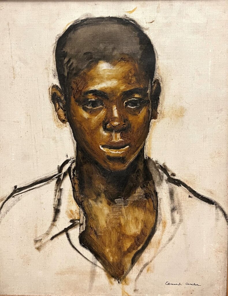 Portrait of a young Black boy in a white collared shirt.